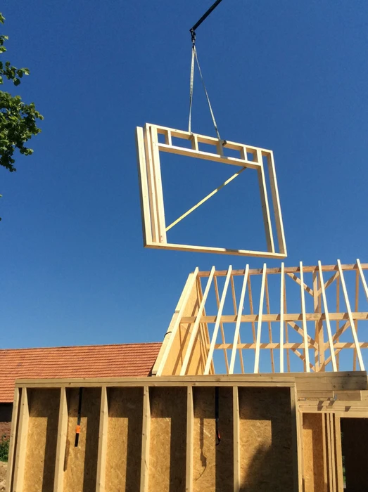Chantier de construction en ossature bois, ciel bleu dégagé