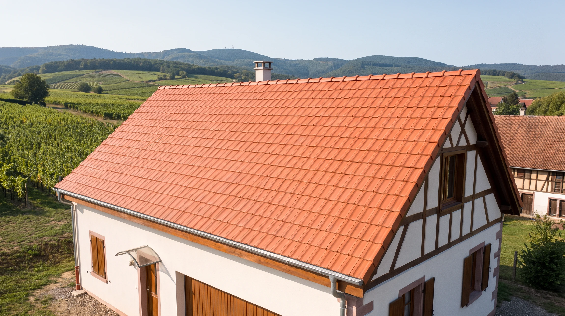 Façade moderne d'un bâtiment résidentiel avec toiture métallique grise à joints debout et lucarnes intégrées